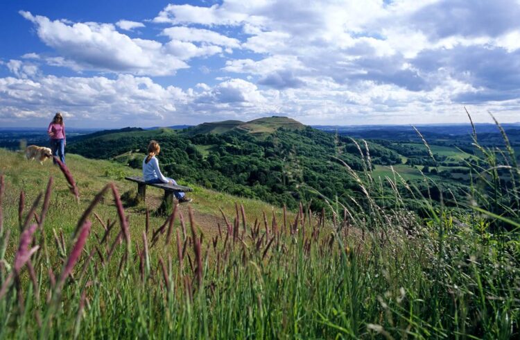 Girl sitting on a bench on the Malvern Hills