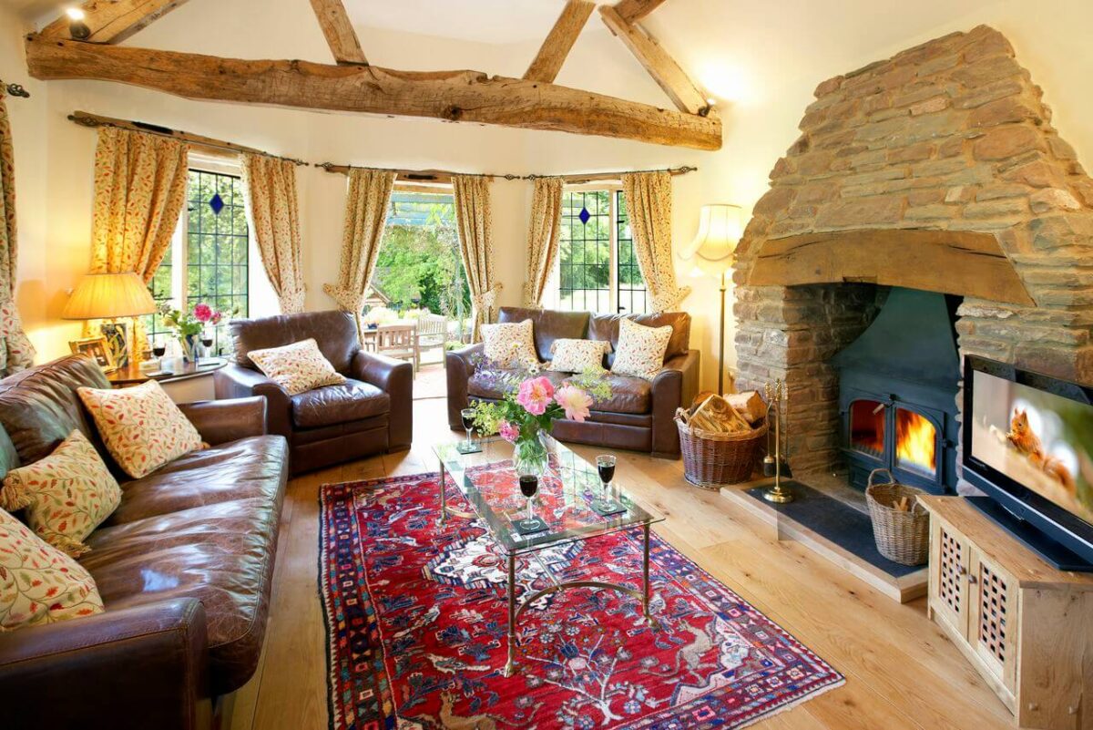 Long Cover Cottage Living room with beams and woodburner