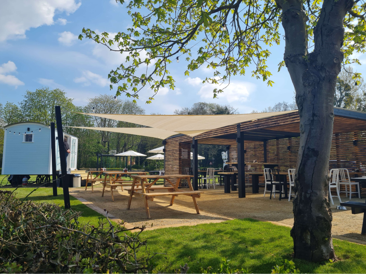 Covered out door seating on a sunny day at the Rose and Crown