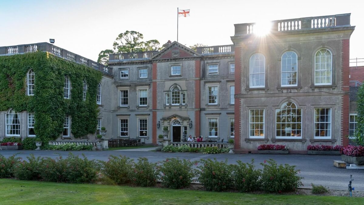 View of the front of the Elms Hotel, with flag flying overhead