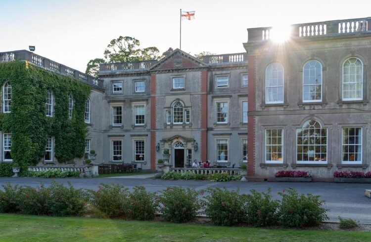 View of the front of the Elms Hotel, with flag flying overhead