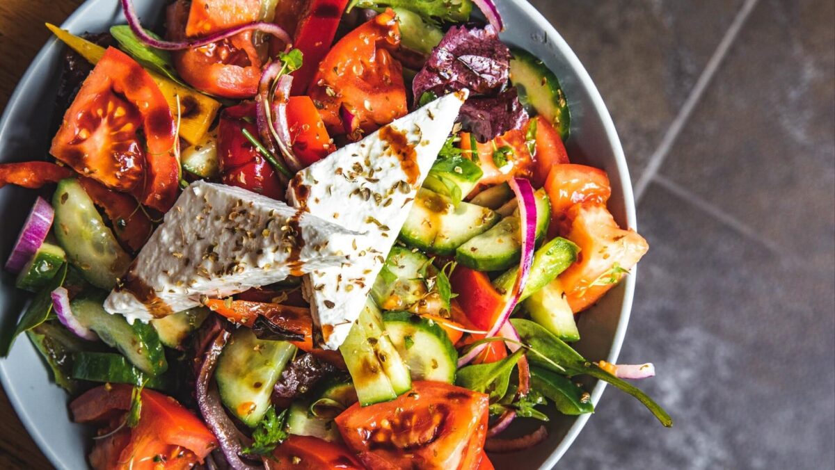 A Mediterranean style dish with tomatoes, red onion, cucumber and feta, with dressing