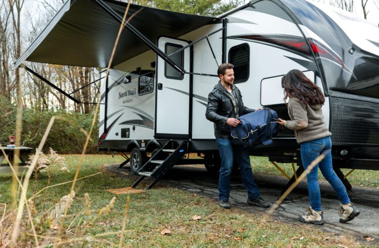 A couple unpacking their caravan