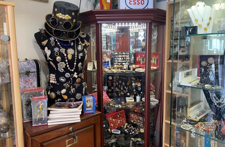 Glass shop cabinets filled with vintage brooches and jewellery