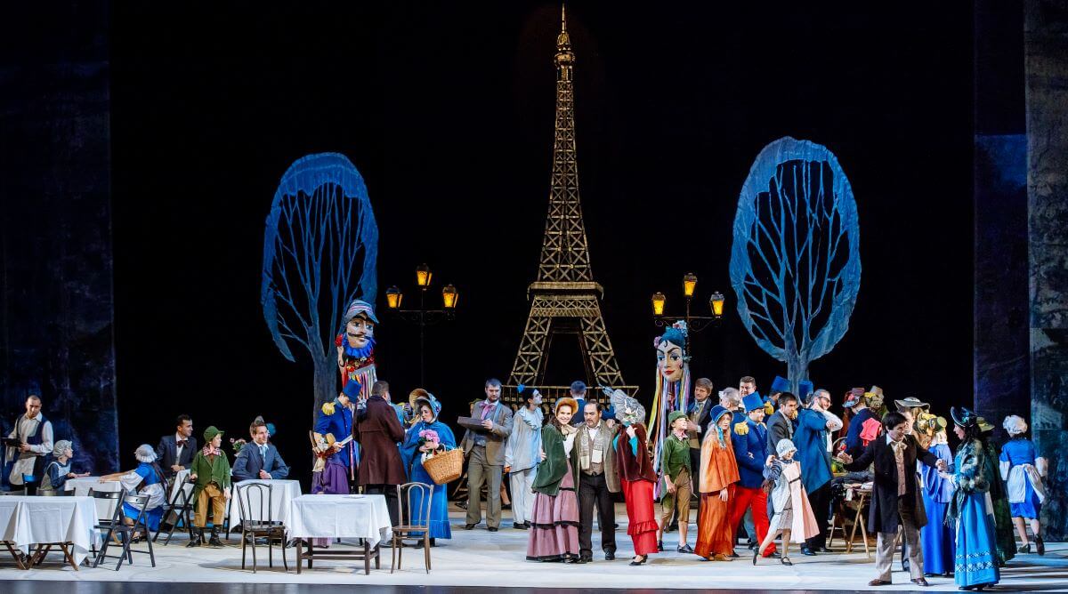 The cast of La boheme with the Eiffel tower.