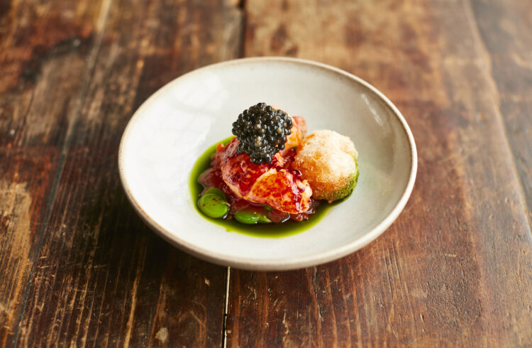 A white bowl on rustic table showing fine dining food