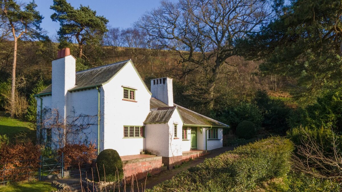 Exterior of The Lodge Holiday Cottage at Perrycroft with trees in background