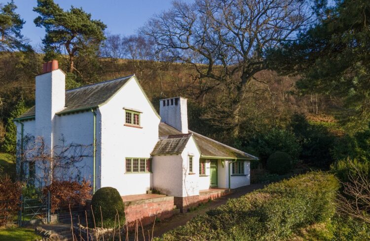 Exterior of The Lodge Holiday Cottage at Perrycroft with trees in background