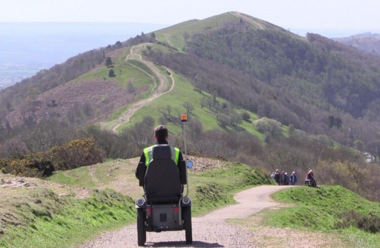 A person riding a mobility scooter on the malvern hills