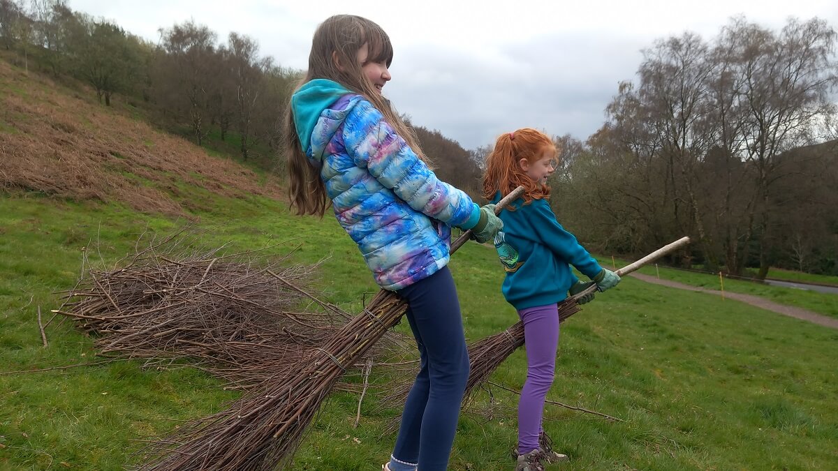 Two children at the birch broom making workshop