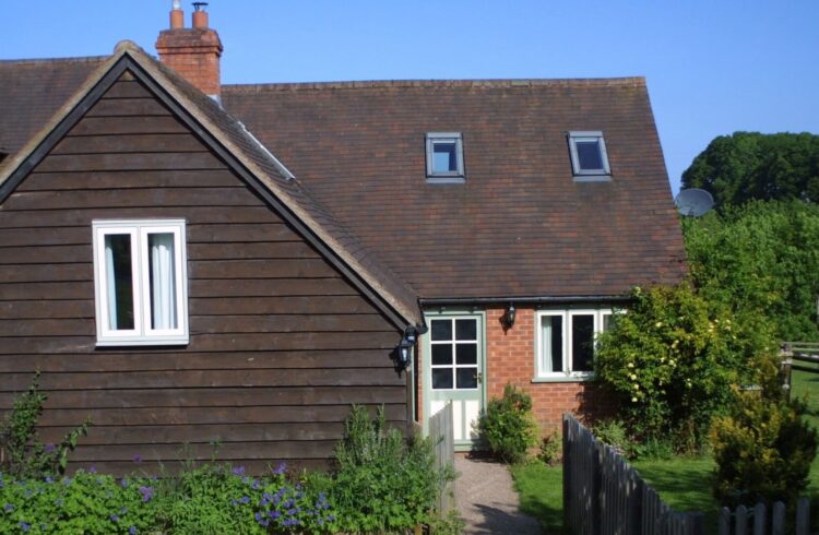 Daisy Cottage exterior view with grass and plants to front of property