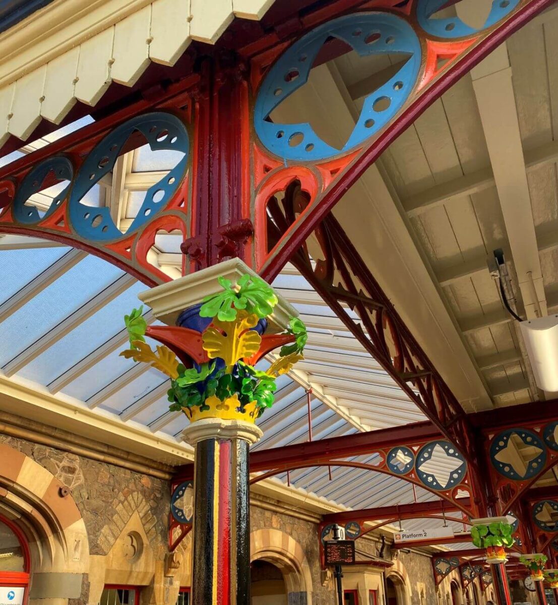 A restored Victorian Train station showing colourful metalwork