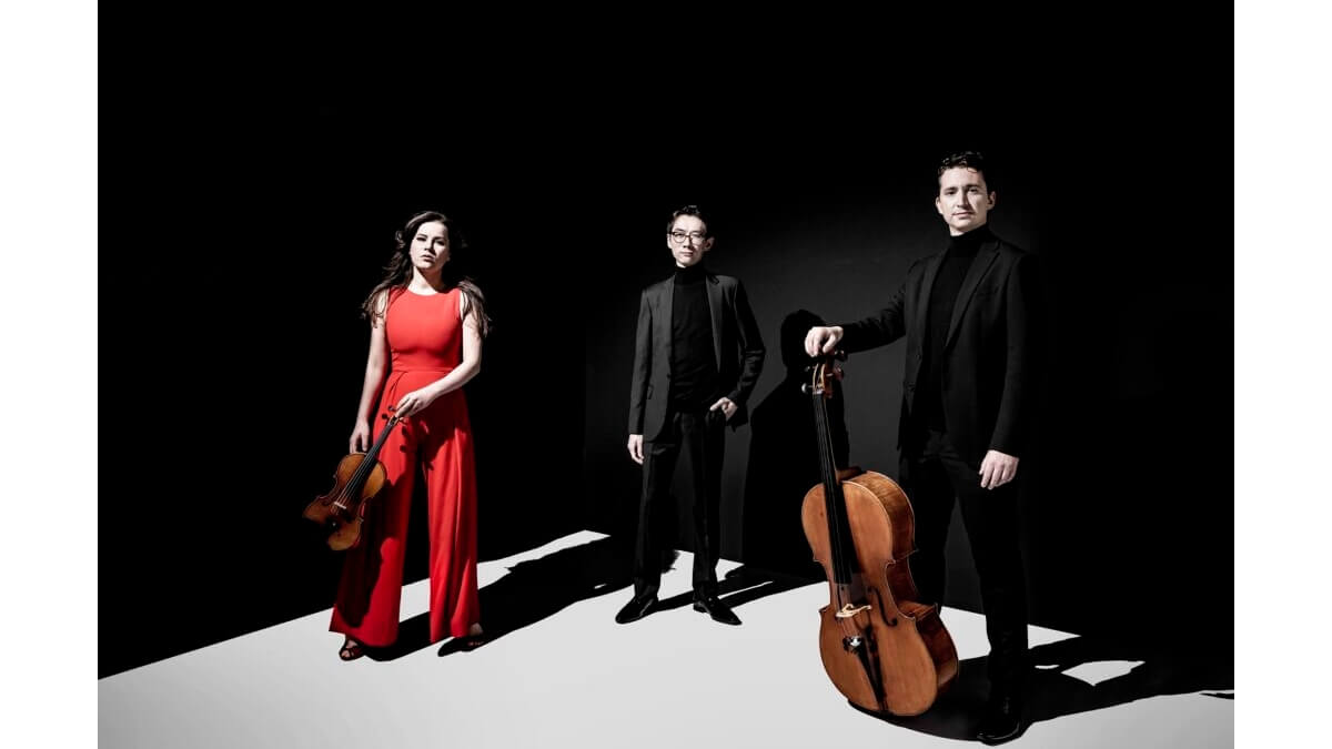 Members of the Amatis Piano Trio dressed in black or red