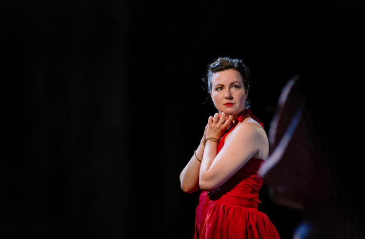 Lady in red dress with a black background