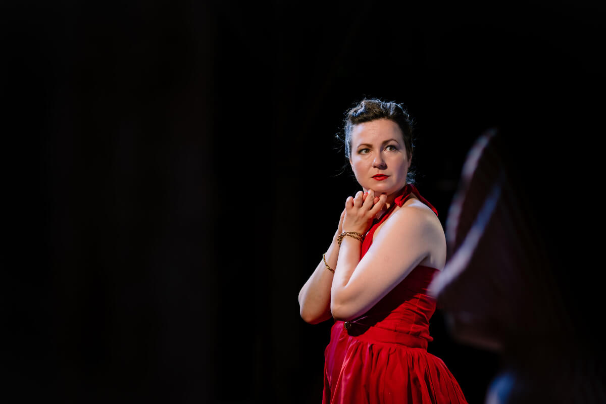 Lady in red dress with a black background