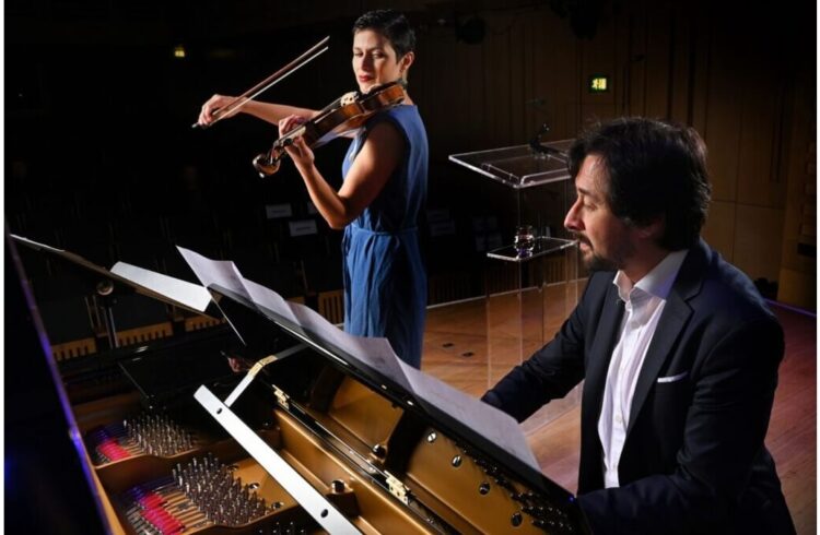 Tom Poster & Elena Urioste playing their instruments on stage