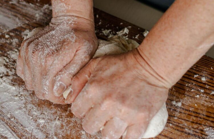 A person kneading dough