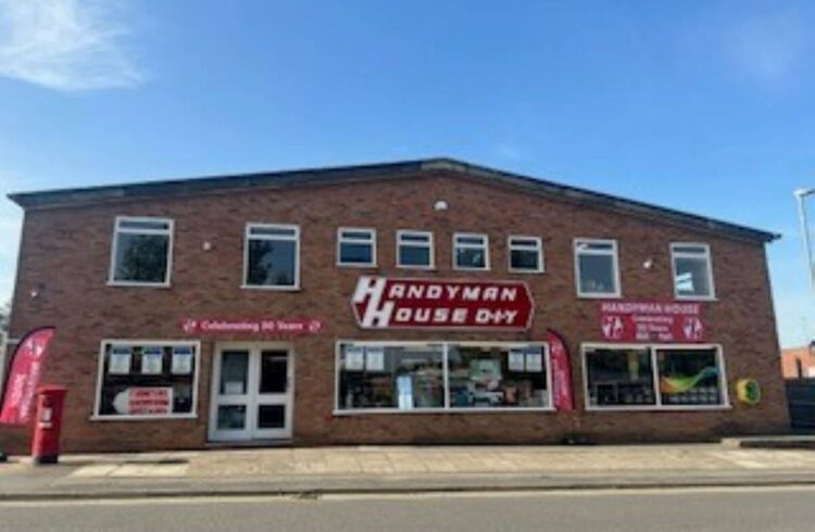 a brick hardware shop with bright blue sky