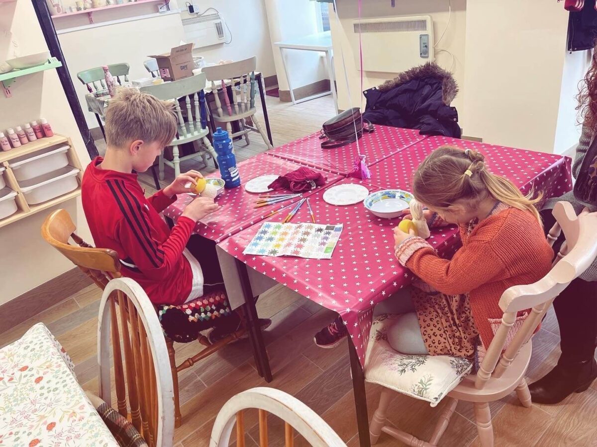 2 Children painting pottery