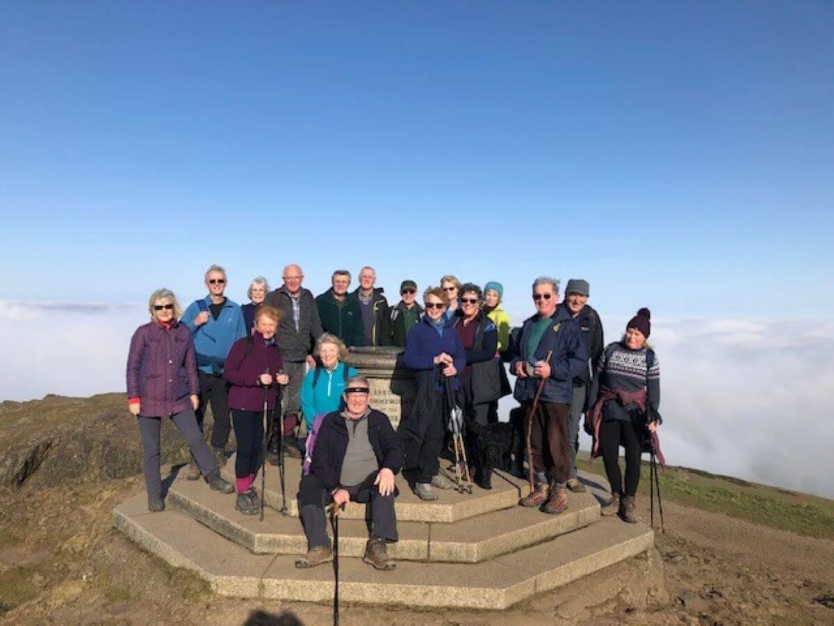 A group of walkers stand on top of a hill