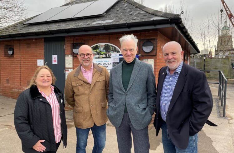 Four people stand in a car park