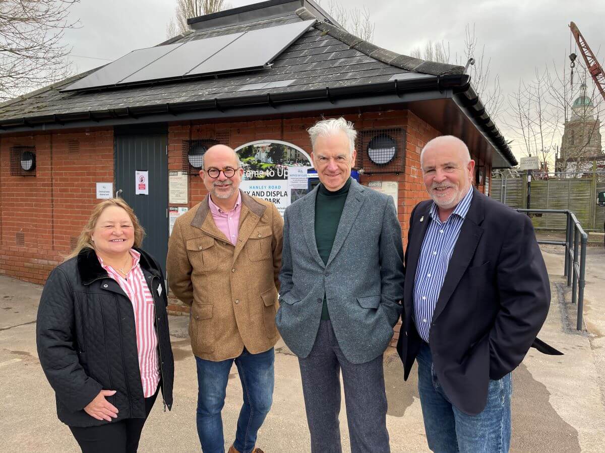 Four people stand in a car park