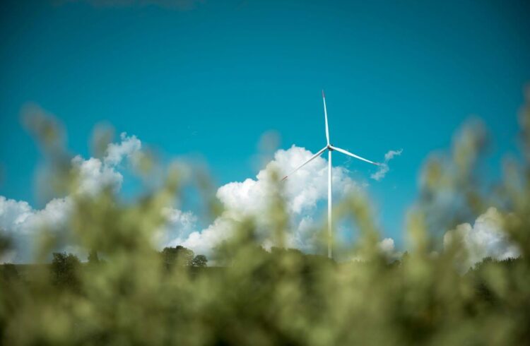 A wind turbine against blue sky