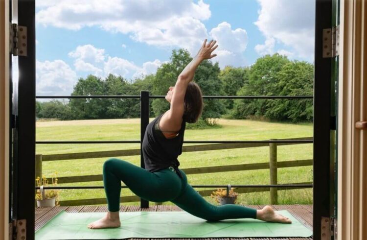 A person doing yoga in a rural setting