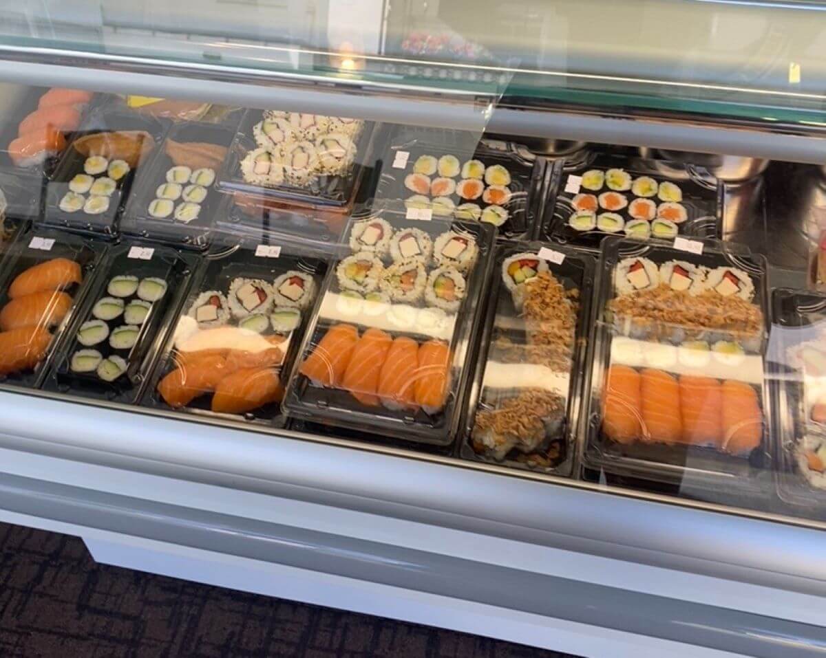 a shop counter displaying sushi