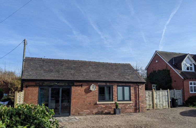 A small converted brick outbuilding