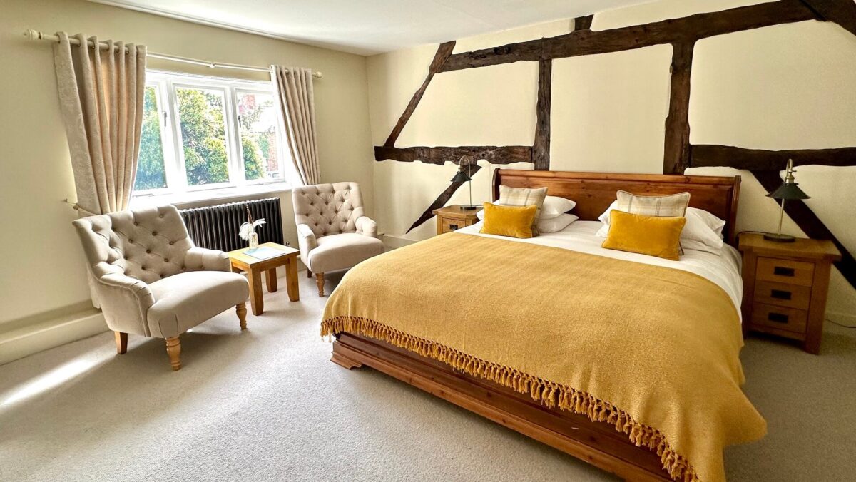 A bedroom decorated in shades of cream, yellow and gold