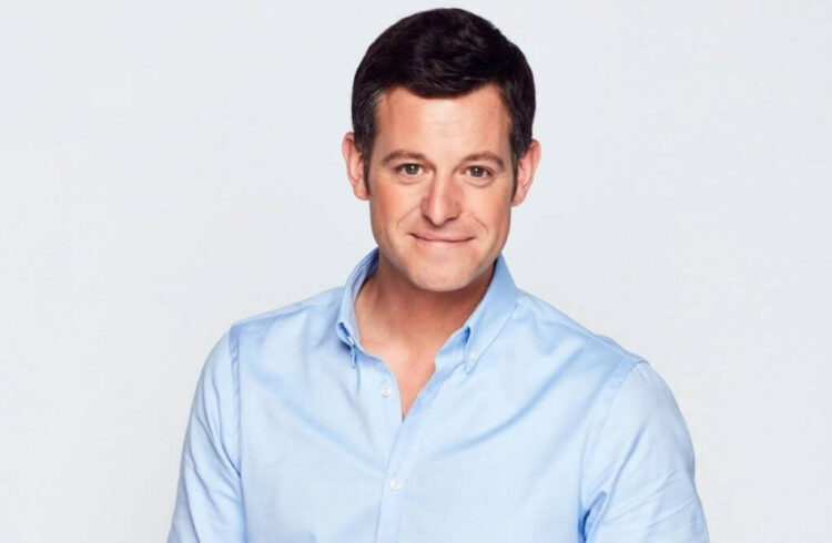 Headshot of a man in a blue shirt