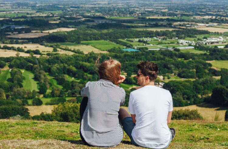 A couple look at the view from the Malvern Hills