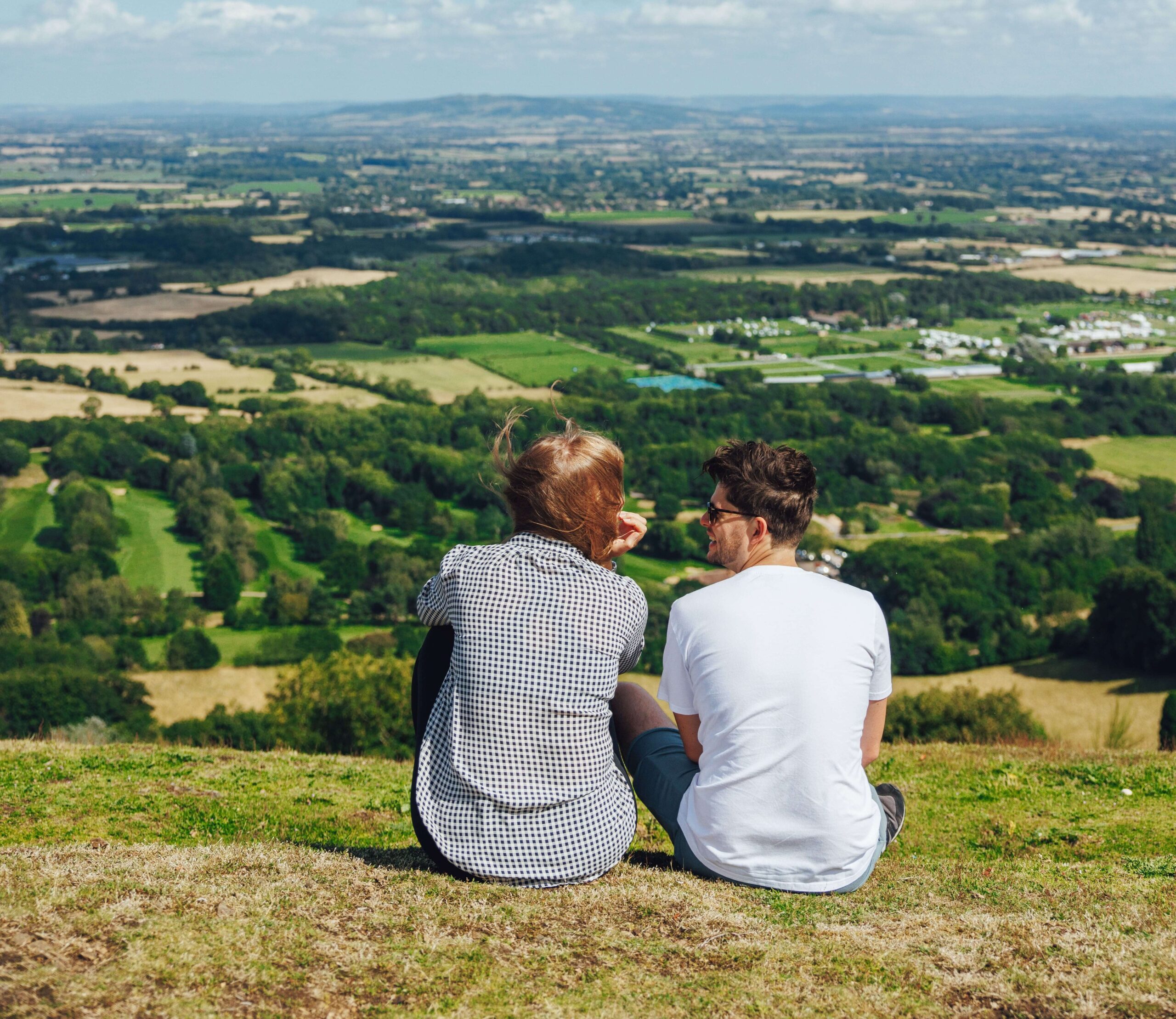 A couple look at the view from the Malvern Hills