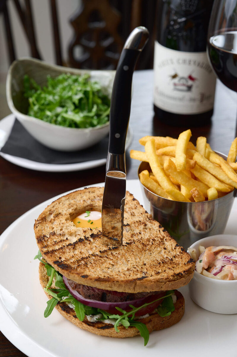 a fried egg sandwich and chips