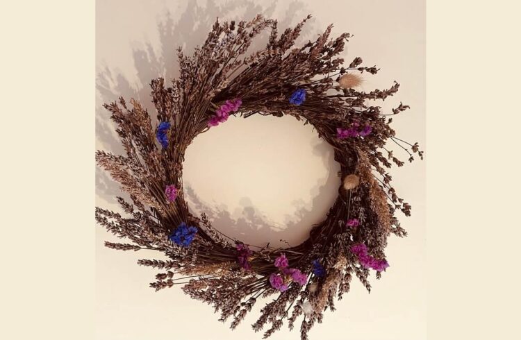 A floral wreath featuring blue and purple flowers