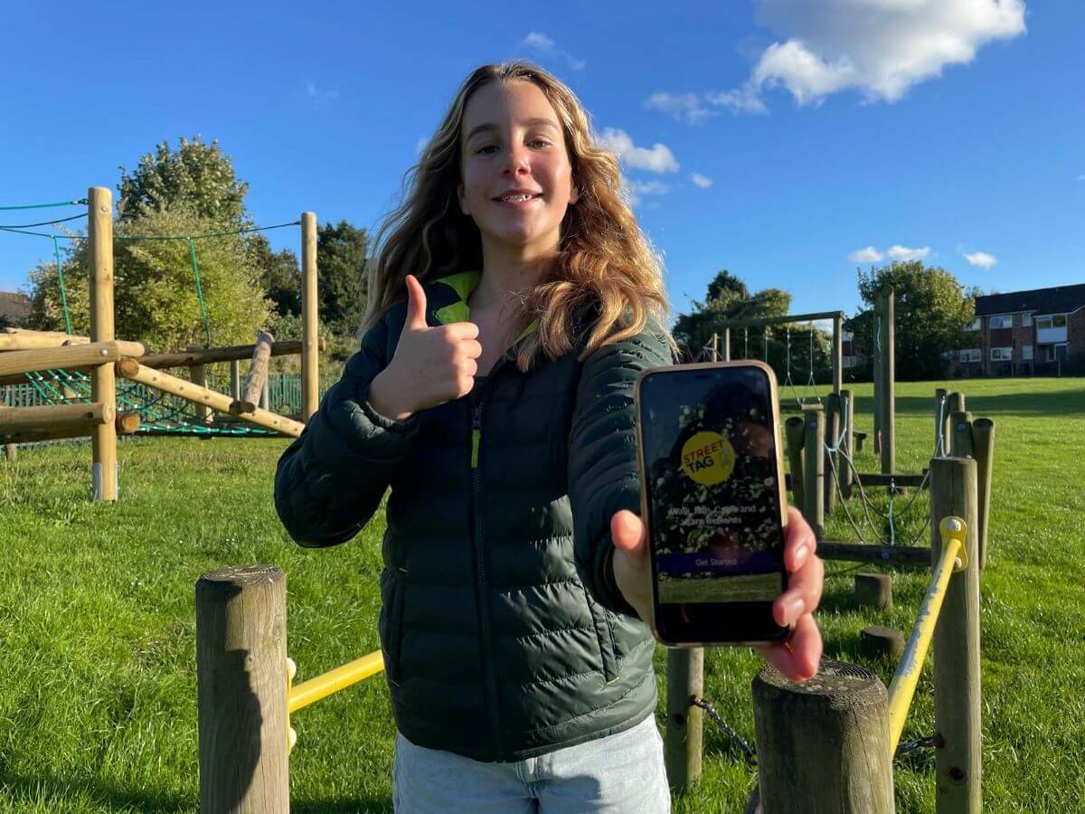 A child holding a phone in a play area