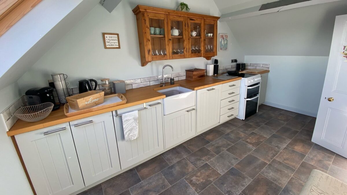 Kitchen with oven and hob, sink and other appliances