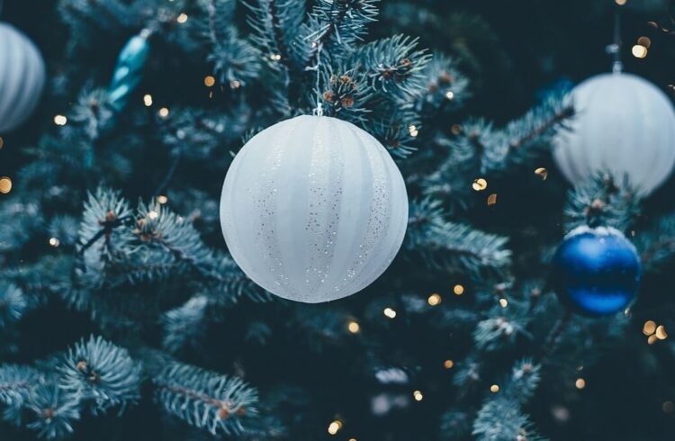 A Christmas tree decorated with glittery white and blue baubles