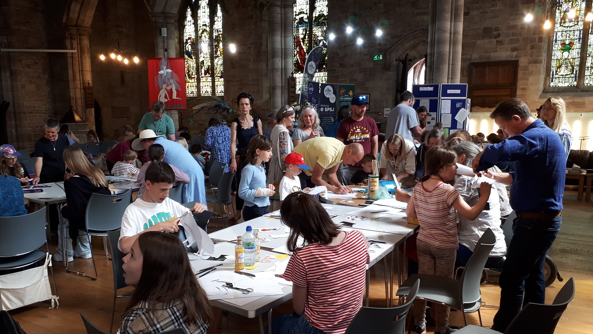 Families working on craft projects in a church