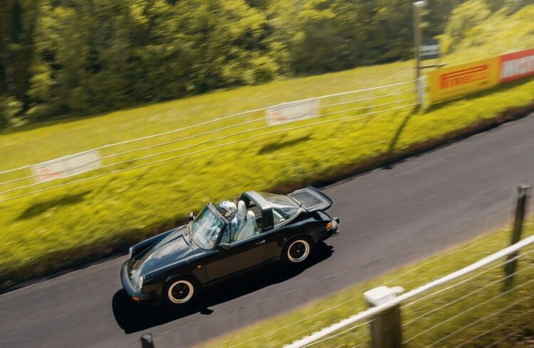 A convertible Porsche being driven at Shelsley Walsh Hill Climb